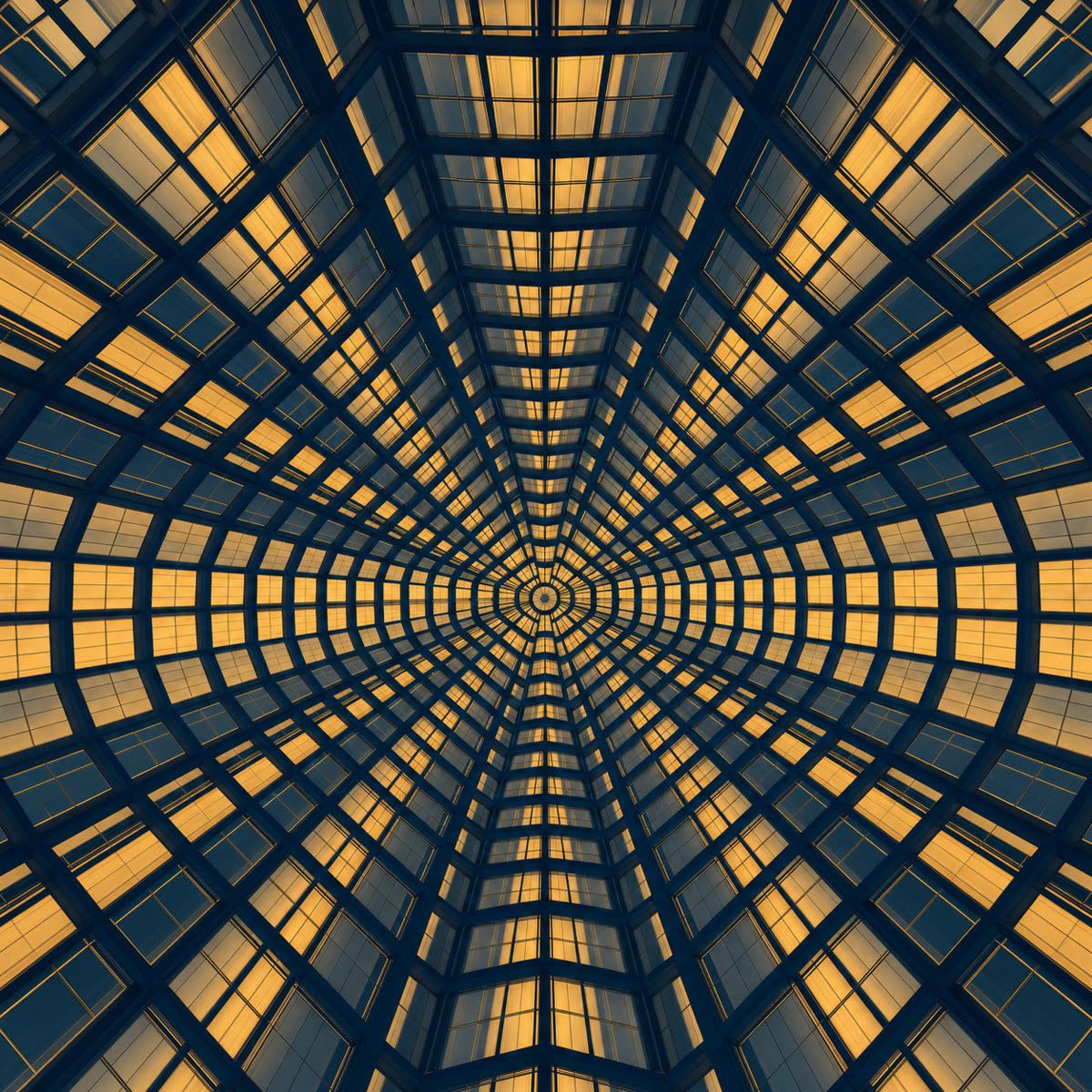 Symmetrical steel-and-glass atrium ceiling receding to a central point